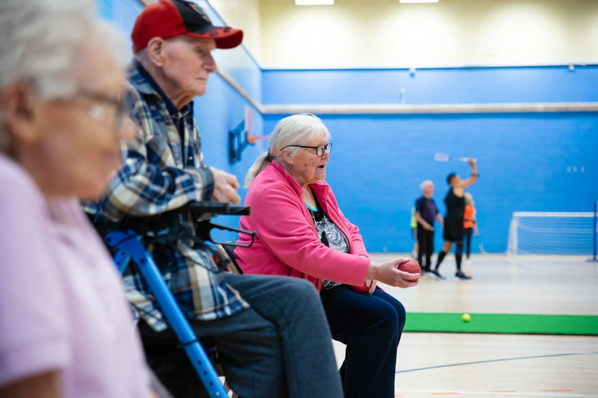 Older adults playing a game together in a gymnasium